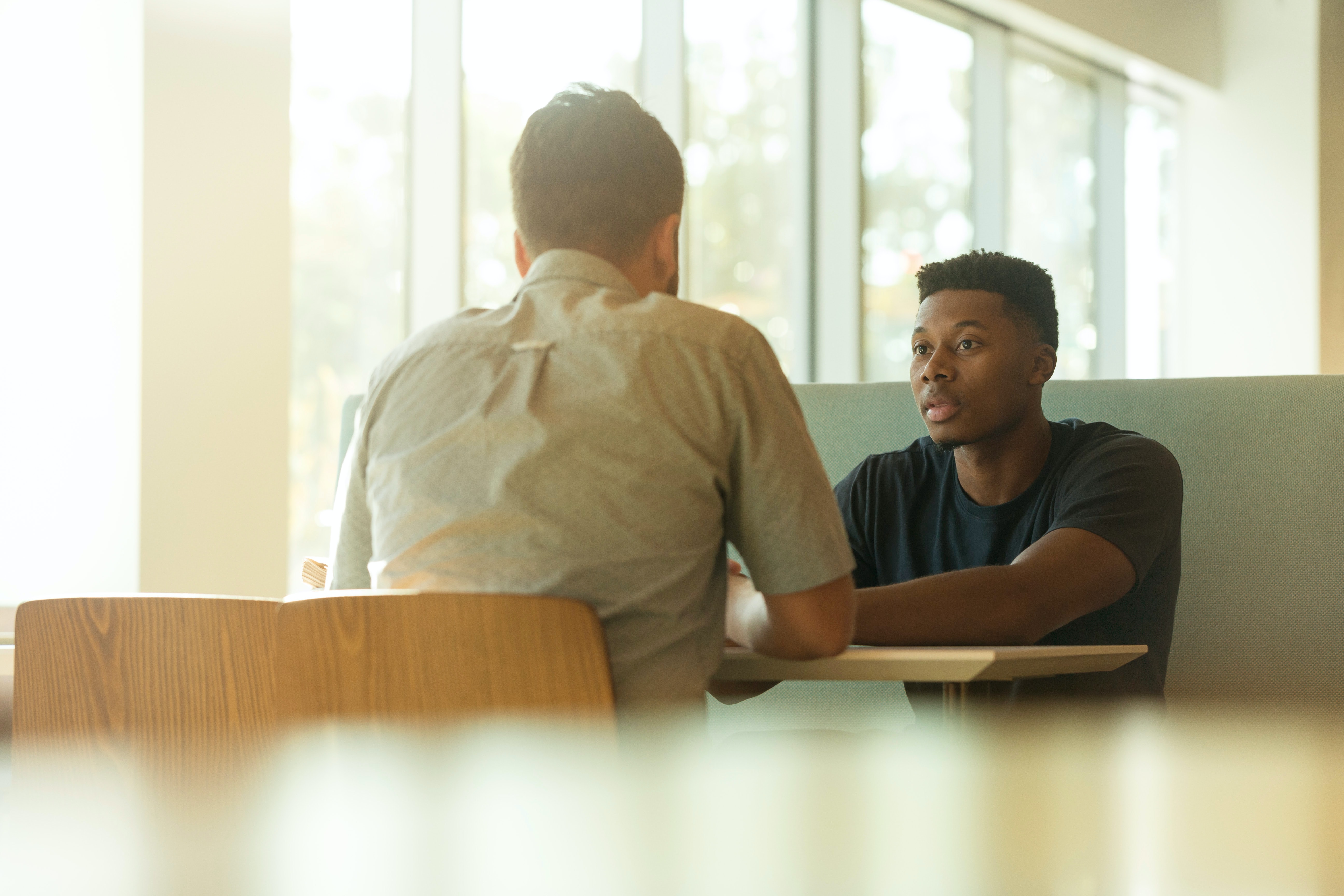 Two men meeting at a table